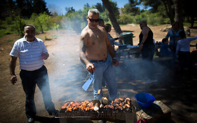 Illustrative: A man barbecues during the Passover holiday in Jerusalem, April 5, 2015. (Yonatan Sindel/Flash90)