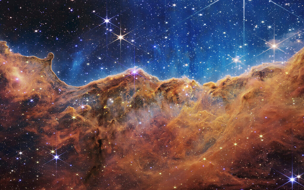 This image released by NASA on Tuesday, July 12, 2022, shows the edge of a nearby, young, star-forming region NGC 3324 in the Carina Nebula. (NASA, ESA, CSA, and STScI via AP) This image released by NASA on Tuesday, July 12, 2022, shows the edge of a nearby, young, star-forming region NGC 3324 in the Carina Nebula. (NASA, ESA, CSA, and STScI via AP)