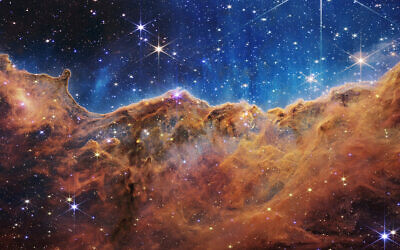 This image released by NASA on Tuesday, July 12, 2022, shows the edge of a nearby, young, star-forming region NGC 3324 in the Carina Nebula. (NASA, ESA, CSA, and STScI via AP)