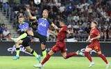 Tottenham Hotspur's English striker Harry Kane, 2nd from left, vies for the ball with Roma's Brazilian defender Roger, center, during a friendly match between England's Tottenham Hotspurs and Italy's AS Roma at the Sammy Ofer Stadium in Haifa, July 30, 2022. (Jack Guez/AFP)