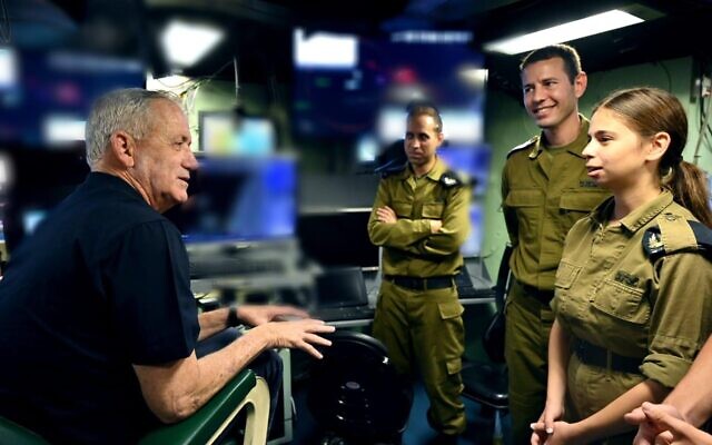 Defense Minister Benny Gantz speaks with IDF Sgt. Shachar Furman at the Haifa naval base, July 12, 2022. (Ariel Hermoni/Defense Ministry) Defense Minister Benny Gantz speaks with IDF Sgt. Shachar Furman at the Haifa naval base, July 12, 2022. (Ariel Hermoni/Defense Ministry)