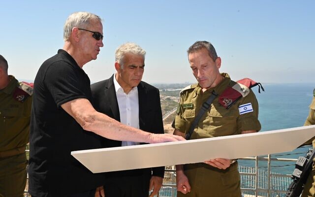 Defense Minister Benny Gantz (right) Prime Minister Yair Lapid (center) and Northern Command chief Amir Baram on the Lebanese border, near the coast, on July 19, 2022. (Amos Ben Gershom/ GPO) Defense Minister Benny Gantz (right) Prime Minister Yair Lapid (center) and Northern Command chief Amir Baram on the Lebanese border, near the coast, on July 19, 2022. (Amos Ben Gershom/ GPO)