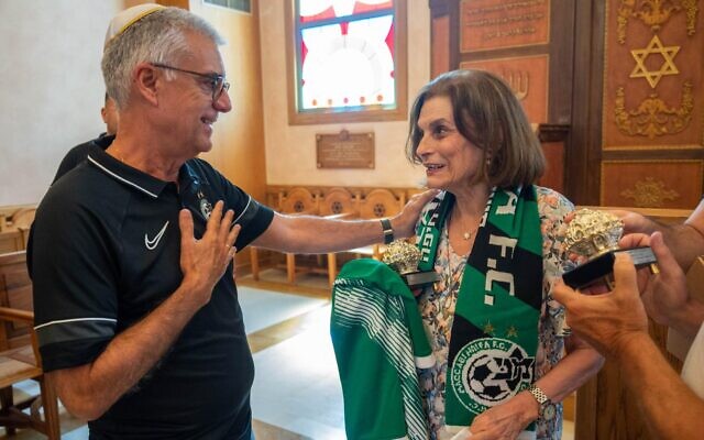 Uzi Mor, vice president of Maccabi Haifa, with Holocaust survivor Emmy Mekiou in a synagogue in Athens on July 26, 2022 (Courtesy Shahar Azran / WJC) Uzi Mor, vice president of Maccabi Haifa, with Holocaust survivor Emmy Mekiou in a synagogue in Athens on July 26, 2022 (Courtesy Shahar Azran / WJC)