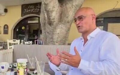 Dudi Ashkenazi at a cafe in Kos, Greece, in footage aired on July 6, 2022. (Screen capture/Channel 12) Dudi Ashkenazi at a cafe in Kos, Greece, in footage aired on July 6, 2022. (Screen capture/Channel 12)