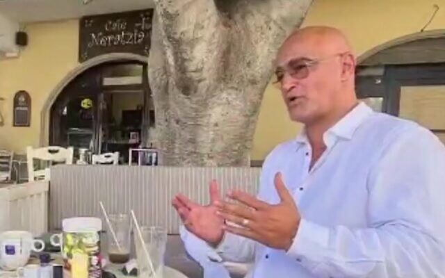 Dudi Ashkenazi at a cafe in Kos, Greece, in footage aired on July 6, 2022. (Screen capture/Channel 12) Dudi Ashkenazi at a cafe in Kos, Greece, in footage aired on July 6, 2022. (Screen capture/Channel 12)