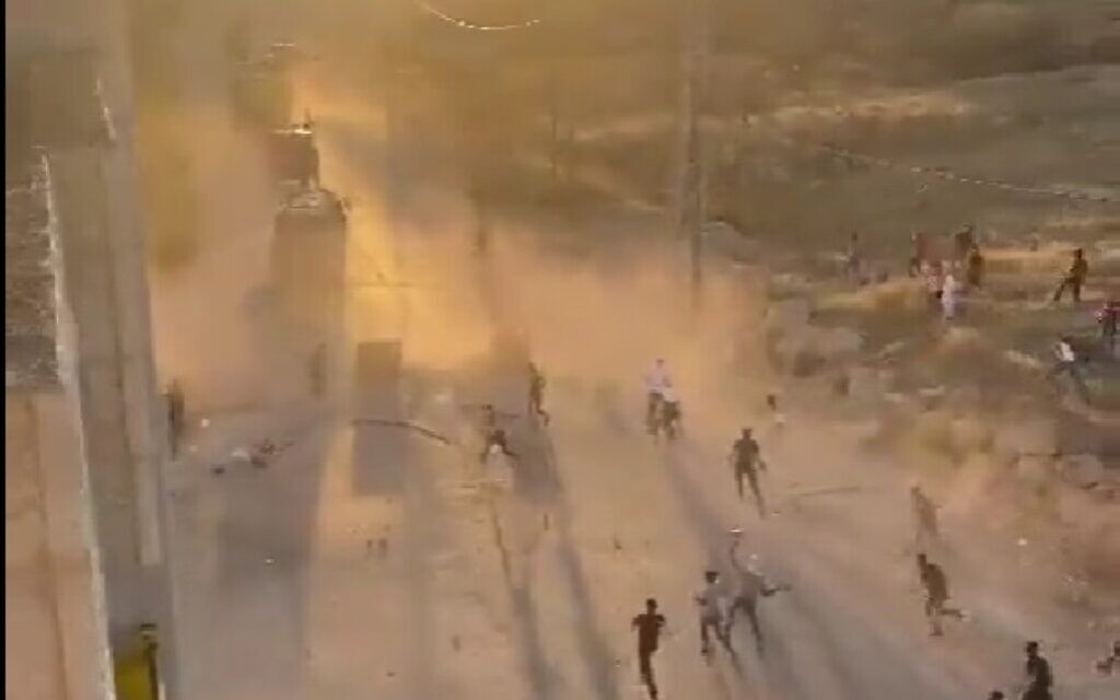 Palestinians throw rocks at Israeli military vehicles near Hebron on July 4, 2022. (Screen capture: Twitter) Palestinians throw rocks at Israeli military vehicles near Hebron on July 4, 2022. (Screen capture: Twitter)