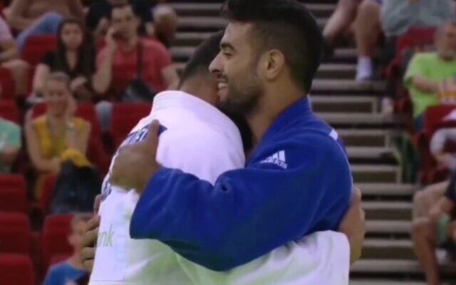 Israeli judoka Sagi Muki embraces champion Saeid Mollaei after their match, at the 2022 Judo Grand Slam in Budapest, July 9, 2022. Mollaei is now representing Azerbaijan. (Video screenshot)