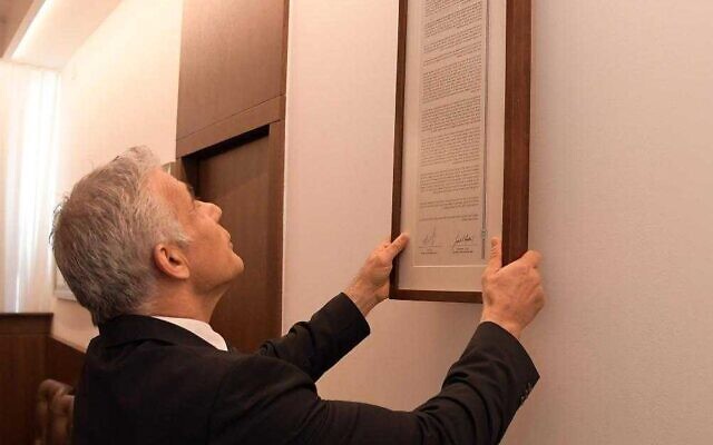 Prime Minister Yair Lapid hangs up the Jerusalem Declaration, signed by Israel and the US, in the cabinet meeting room in Jerusalem, July 17, 2022 (Haim Zach/GPO) Prime Minister Yair Lapid hangs up the Jerusalem Declaration, signed by Israel and the US, in the cabinet meeting room in Jerusalem, July 17, 2022 (Haim Zach/GPO)