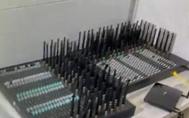 The machines used to send millions of text messages a day offering drugs in a Channel 12 news report broadcast on July 22, 2022. (Screengrab/Israel Police via Channel 12) The machines used to send millions of text messages a day offering drugs in a Channel 12 news report broadcast on July 22, 2022. (Screengrab/Israel Police via Channel 12)