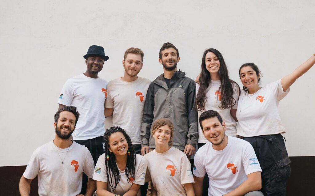 First Afrikan delegation to Malindi, Tanzania pose for a group photo with Malindi ward councilor Msumba Eliya (top row, far left). Back row: Rafi Ryker, Elyasaf Tsarum, Tal Englender, Achinoam Carmi. Bottom row from left: Bar Orian, Talia Amir, Carmel Cohen, Idan Arad. (Idan Arad/Courtesy of Afrikan)
