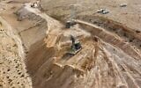 In this image issued by the Israeli military on July 21, 2022, engineering vehicles work to dig a trench along the border with the West Bank in the Judaean Desert area. (Israel Defense Forces)