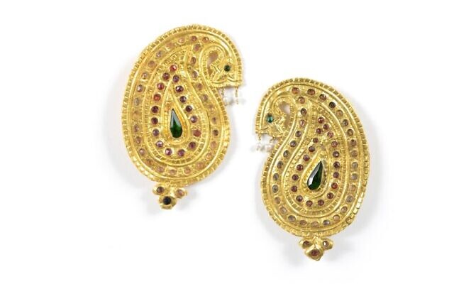 A set of gold pins in the shape of a 'buteh,' the Persian term for paisley, at 'Paisley, A Princely Pattern,' a new exhibit at Jerusalem's Museum of Islamic Art (Courtesy Shai Ben Efraim)
