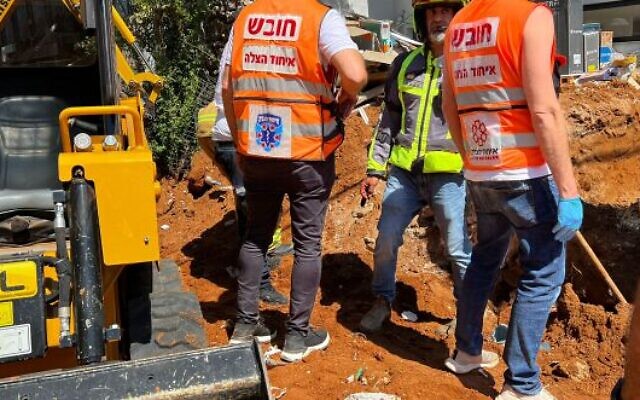 Rescue workers try and free a man who was trapped under a collapsed wall at a building site in Herzliya on July 18, 2022. The man later died. (United Hatzalah) Rescue workers try and free a man who was trapped under a collapsed wall at a building site in Herzliya on July 18, 2022. The man later died. (United Hatzalah)