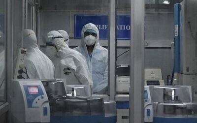 Technicians wearing personal protective equipment (PPE) suits are seen inside a molecular laboratory facility set up to test for monkeypox, during its inauguration at the King Institute in Chennai, July 28, 2022. (Arun Sankar/AFP)