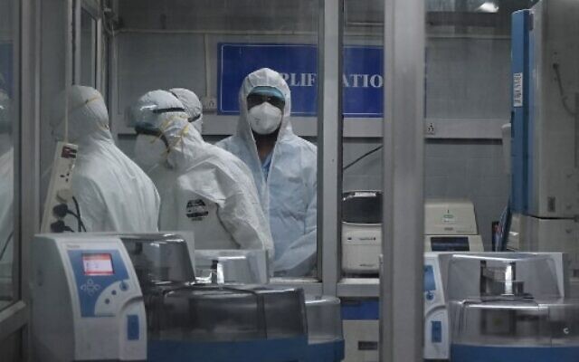Technicians wearing personal protective equipment (PPE) suits are seen inside a molecular laboratory facility set up to test for monkeypox, during its inauguration at the King Institute in Chennai, July 28, 2022. (Arun Sankar/AFP) Technicians wearing personal protective equipment (PPE) suits are seen inside a molecular laboratory facility set up to test for monkeypox, during its inauguration at the King Institute in Chennai, July 28, 2022. (Arun Sankar/AFP)