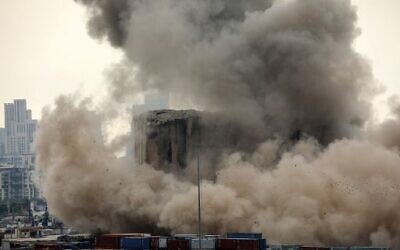 Heavy dust rises as part of the grain silos in the port of Beirut collapse on the 2nd anniversary of a deadly blast which killed over 200 people, August 4, 2022. (Ibrahim Amro/AFP)