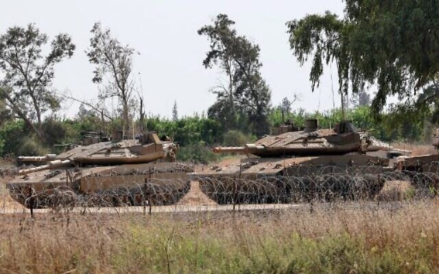 Israeli army Mercava tanks are pictured on the Israel-Gaza border on July 5, 2022. The Israeli military said today it launched airstrikes on Gaza, which were witnessed by Palestinians in central Gaza City. (Photo by JACK GUEZ / AFP) Israeli army Mercava tanks are pictured on the Israel-Gaza border on July 5, 2022. The Israeli military said today it launched airstrikes on Gaza, which were witnessed by Palestinians in central Gaza City. (Photo by JACK GUEZ / AFP)