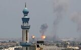 Smoke billows from an Israeli air strike in Khan Younis in the southern Gaza Strip on August 6, 2022. (AFP)