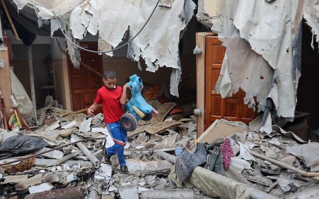 A Palestinian youth salvages a toy from the rubble of his house which was destroyed during the latest three days of conflict with Israel ahead of a truce, in Rafah town in the southern Gaza Strip, on August 8, 2022. (SAID KHATIB / AFP) A Palestinian youth salvages a toy from the rubble of his house which was destroyed during the latest three days of conflict with Israel ahead of a truce, in Rafah town in the southern Gaza Strip, on August 8, 2022. (SAID KHATIB / AFP)