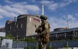 A Russian serviceman patrols the territory of the Zaporizhzhia Nuclear Power Station in Energodar, Ukraine. The photo was taken during a media trip led by the Russian military, May 1, 2022. (Andrey Borodulin/AFP)