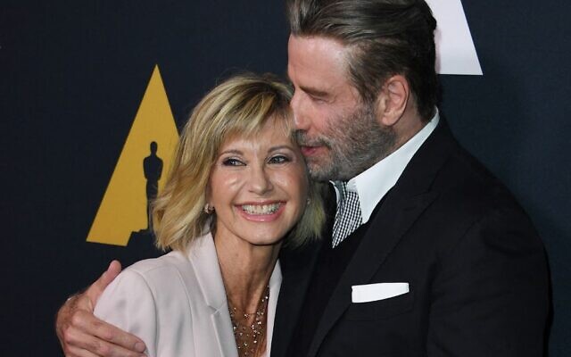 In this file photo taken on August 15, 2018 actors Olivia Newton-John and John Travolta pose on the red carpet as they arrive for the 40th anniversary celebration of the movie 'Grease' at the Academy of Motion Picture Arts and Sciences (AMPAS) in Beverly Hills, California. (Mark RALSTON / AFP)