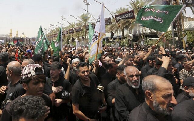 Shiite Muslims take part in the 'Tuwairij run' ritual as they mark the peak of Ashura, a 10-day mourning period commemorating the seventh century killing of Prophet Mohammed's grandson Imam Hussein, in Iraq's holy city of Karbala, on August 9, 2022. (Sabah ARAR / AFP) Shiite Muslims take part in the 'Tuwairij run' ritual as they mark the peak of Ashura, a 10-day mourning period commemorating the seventh century killing of Prophet Mohammed's grandson Imam Hussein, in Iraq's holy city of Karbala, on August 9, 2022. (Sabah ARAR / AFP)