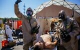 Ukrainian Emergency Ministry rescuers attend an exercise in the city of Zaporizhzhia on August 17, 2022, in case of a possible nuclear incident at the Zaporizhzhia nuclear power plant located near the city. (Dimitar Dilkoff/AFP)