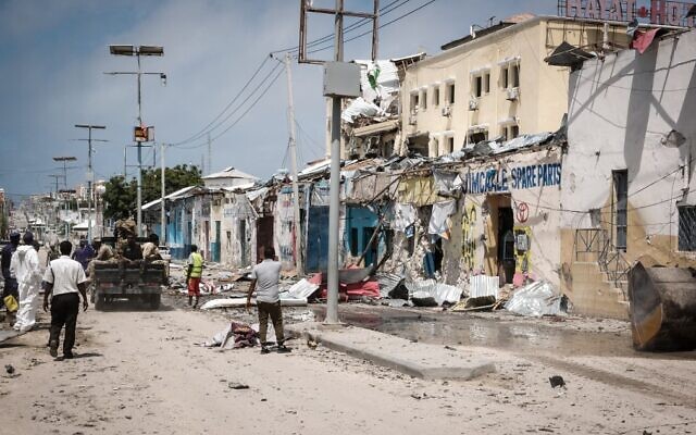 People watch outside the destroyed Hayat Hotel after a deadly 30-hour siege by al-Shabaab jihadists in Mogadishu, Somalia, on August 21, 2022. (Hassan Ali Elmi/AFP) People watch outside the destroyed Hayat Hotel after a deadly 30-hour siege by al-Shabaab jihadists in Mogadishu, Somalia, on August 21, 2022. (Hassan Ali Elmi/AFP)