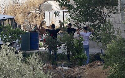 Nabeel Sawalhi and Nihad Owais (right) surrender to Israeli troops after a gun battle in the northern West Bank town of Rujeib near Nablus, August 30, 2022. (JAAFAR ASHTIYEH / AFP)