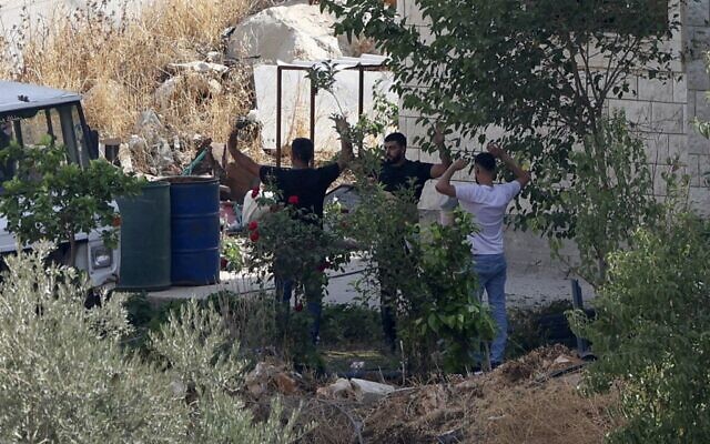 Nabeel Sawalhi and Nihad Owais (right) surrender to Israeli troops after a gun battle in the northern West Bank town of Rujeib near Nablus, August 30, 2022. (JAAFAR ASHTIYEH / AFP) Nabeel Sawalhi and Nihad Owais (right) surrender to Israeli troops after a gun battle in the northern West Bank town of Rujeib near Nablus, August 30, 2022. (JAAFAR ASHTIYEH / AFP)