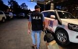 A member of an International Atomic Energy Agency (IAEA) inspection team walks in front of the Hyatt hotel in Kyiv on August 31, 2022, before departing to the Russian-held Zaporizhzhia nuclear power plant in southern Ukraine. (SERGEI CHUZAVKOV/AFP)
