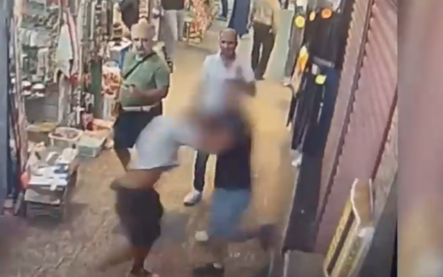An ice cream store owner (right) assaults an American tourist in his 50s during an argument over the price of a purchase in Jerusalem's Old City, August 19, 2022. (Screenshot/Twitter) An ice cream store owner (right) assaults an American tourist in his 50s during an argument over the price of a purchase in Jerusalem's Old City, August 19, 2022. (Screenshot/Twitter)