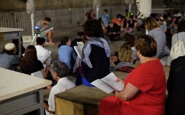 People gather to hear a reading of the Book of Lamentations at the egalitarian section of the Western Wall on August 6, 2022. (Judah Ari Gross/Times of Israel) People gather to hear a reading of the Book of Lamentations at the egalitarian section of the Western Wall on August 6, 2022. (Judah Ari Gross/Times of Israel)
