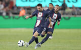 PSG's Lionel Messi, left, kicks the ball during the French Super Cup final soccer match between Nantes and Paris Saint-Germain at Bloomfield Stadium in Tel Aviv, Israel, July 31, 2022. (AP Photo/Ariel Schalit)