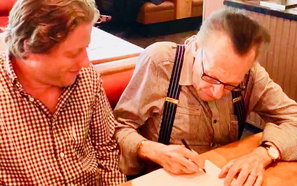 Peter Shapiro, left, with Larry King in this undated photo taken as Shapiro signs a joint venture deal with Live Nation to create new Brooklyn Bowls. (Courtesy)