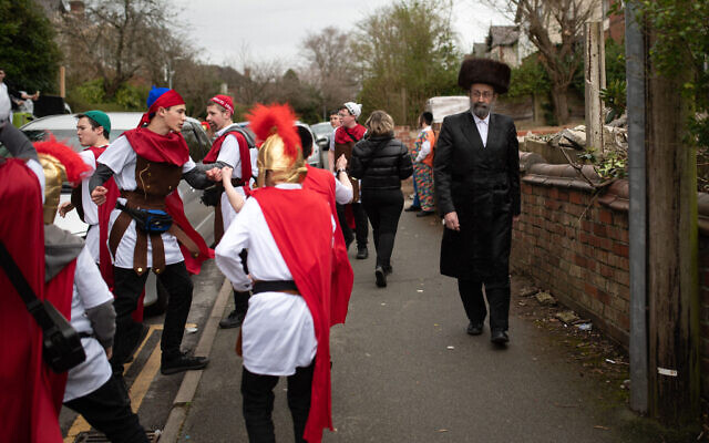 Members of the Jewish community celebrate Purim in Manchester, in northern England, on March 17, 2022. (OLI SCARFF / AFP) Members of the Jewish community celebrate Purim in Manchester, in northern England, on March 17, 2022. (OLI SCARFF / AFP)