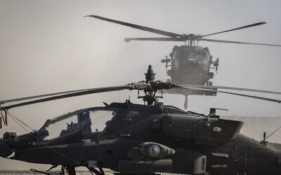 A Blackhawk helicopter lands next to an Apache attack helicopter at a US military base at undisclosed location in Eastern Syria, Nov. 11, 2019. (AP/Darko Bandic) A Blackhawk helicopter lands next to an Apache attack helicopter at a US military base at undisclosed location in Eastern Syria, Nov. 11, 2019. (AP/Darko Bandic)
