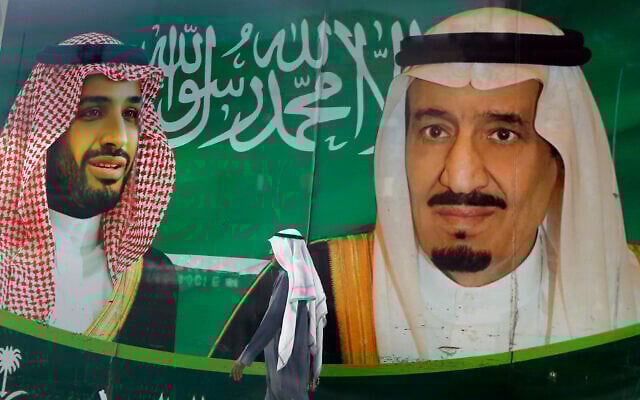 In this March 7, 2020, file photo, a man walks past a banner showing Saudi King Salman, right, and his Crown Prince Mohammed bin Salman, outside a mall in Jiddah, Saudi Arabia. (AP Photo/Amr Nabil, File) In this March 7, 2020, file photo, a man walks past a banner showing Saudi King Salman, right, and his Crown Prince Mohammed bin Salman, outside a mall in Jiddah, Saudi Arabia. (AP Photo/Amr Nabil, File)