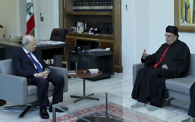 Lebanese president Michel Aoun, left, meets with Lebanese Maronite archbishop Moussa el-Hajj, at the presidential palace, in Baabda east of Beirut, Lebanon, July 22, 2022.  (Dalati Nohra via AP)