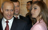 President Vladimir Putin, left, speaks with gymnast Alina Kabaeva at a Kremlin banquet in Moscow, Russia,  Nov. 4, 2004 . (ITAR-TASS, Presidential Press Service/AP)
