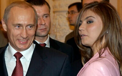 President Vladimir Putin, left, speaks with gymnast Alina Kabaeva at a Kremlin banquet in Moscow, Russia,  Nov. 4, 2004 . (ITAR-TASS, Presidential Press Service/AP)