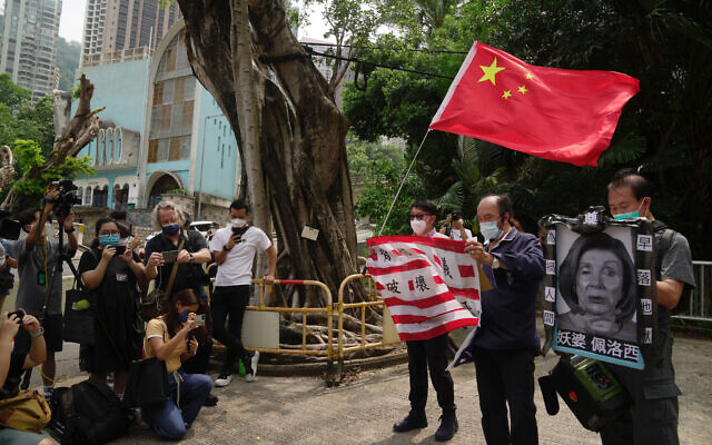 Pro-China supporters hold U.S. flag and a picture of US House Speaker Nancy Pelosi during a protest outside the Consulate General of the United States in Hong Kong, Wednesday, Aug. 3, 2022. U.S. (AP Photo/Kin Cheung) Pro-China supporters hold U.S. flag and a picture of US House Speaker Nancy Pelosi during a protest outside the Consulate General of the United States in Hong Kong, Wednesday, Aug. 3, 2022. U.S. (AP Photo/Kin Cheung)