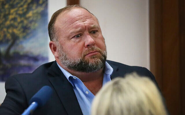 Conspiracy theorist Alex Jones attempts to answer questions about his emails asked by Mark Bankston, lawyer for Neil Heslin and Scarlett Lewis, during trial at the Travis County Courthouse in Austin, Wednesday August 3, 2022. (Briana Sanchez/Austin American-Statesman via AP, Pool) Conspiracy theorist Alex Jones attempts to answer questions about his emails asked by Mark Bankston, lawyer for Neil Heslin and Scarlett Lewis, during trial at the Travis County Courthouse in Austin, Wednesday August 3, 2022. (Briana Sanchez/Austin American-Statesman via AP, Pool)