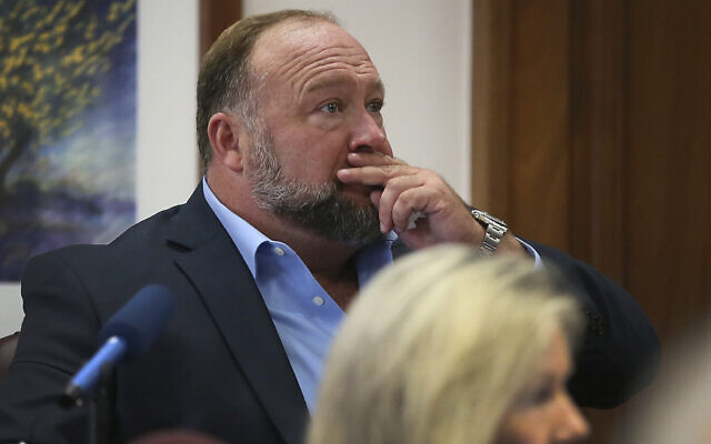 Alex Jones attempts to answer questions about his text messages asked by Mark Bankston, lawyer for Neil Heslin and Scarlett Lewis, during trial at the Travis County Courthouse in Austin, Wednesday Aug. 3, 2022. (Briana Sanchez/Austin American-Statesman via AP, Pool) Alex Jones attempts to answer questions about his text messages asked by Mark Bankston, lawyer for Neil Heslin and Scarlett Lewis, during trial at the Travis County Courthouse in Austin, Wednesday Aug. 3, 2022. (Briana Sanchez/Austin American-Statesman via AP, Pool)
