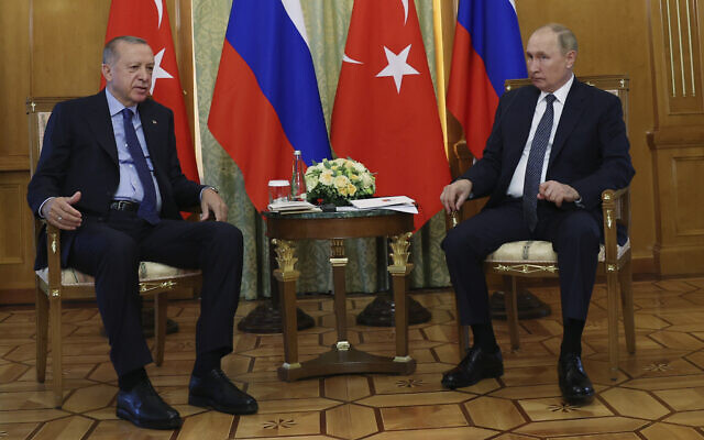 In this handout photo provided by the Turkish Presidency, Turkish President Recep Tayyip Erdogan, left, and Russian President Vladimir Putin speak their meeting at the Rus sanatorium in the Black Sea resort of Sochi, Russia, August 5, 2022. (Turkish Presidency via AP)