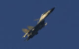 A Chinese J-11 military fighter jet flies above the Taiwan Strait near Pingtan, the closest land of mainland China to the island of Taiwan, in Pingtan in southeastern China's Fujian Province, August 5, 2022. (AP Photo/Ng Han Guan)
