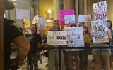 Abortion-rights protesters fill Indiana Statehouse corridors and cheer outside legislative chambers, August 5, 2022, as lawmakers vote to concur on a near-total abortion ban, in Indianapolis. (AP/Arleigh Rodgers)