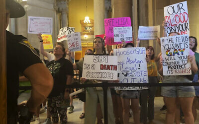 Abortion-rights protesters fill Indiana Statehouse corridors and cheer outside legislative chambers, August 5, 2022, as lawmakers vote to concur on a near-total abortion ban, in Indianapolis. (AP/Arleigh Rodgers)