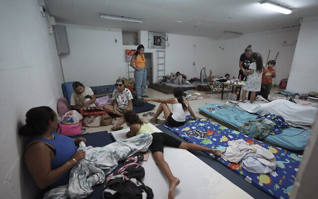 Israelis stay in a bomb shelter following rocket attacks fired by terrorists in the Gaza Strip toward Israel, in Ashkelon, August 7, 2022. (AP Photo/Tsafrir Abayov)