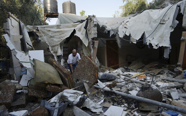 Rami Arada inspects the rubble of his family house after it was destroyed by in Rafah refugee camp, southern Gaza Strip, Monday, Aug. 8, 2022.(AP Photo/Adel Hana) Rami Arada inspects the rubble of his family house after it was destroyed by in Rafah refugee camp, southern Gaza Strip, Monday, Aug. 8, 2022.(AP Photo/Adel Hana)